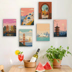 Six finished Postcards from Afar mini paintings hung on a wall above a table