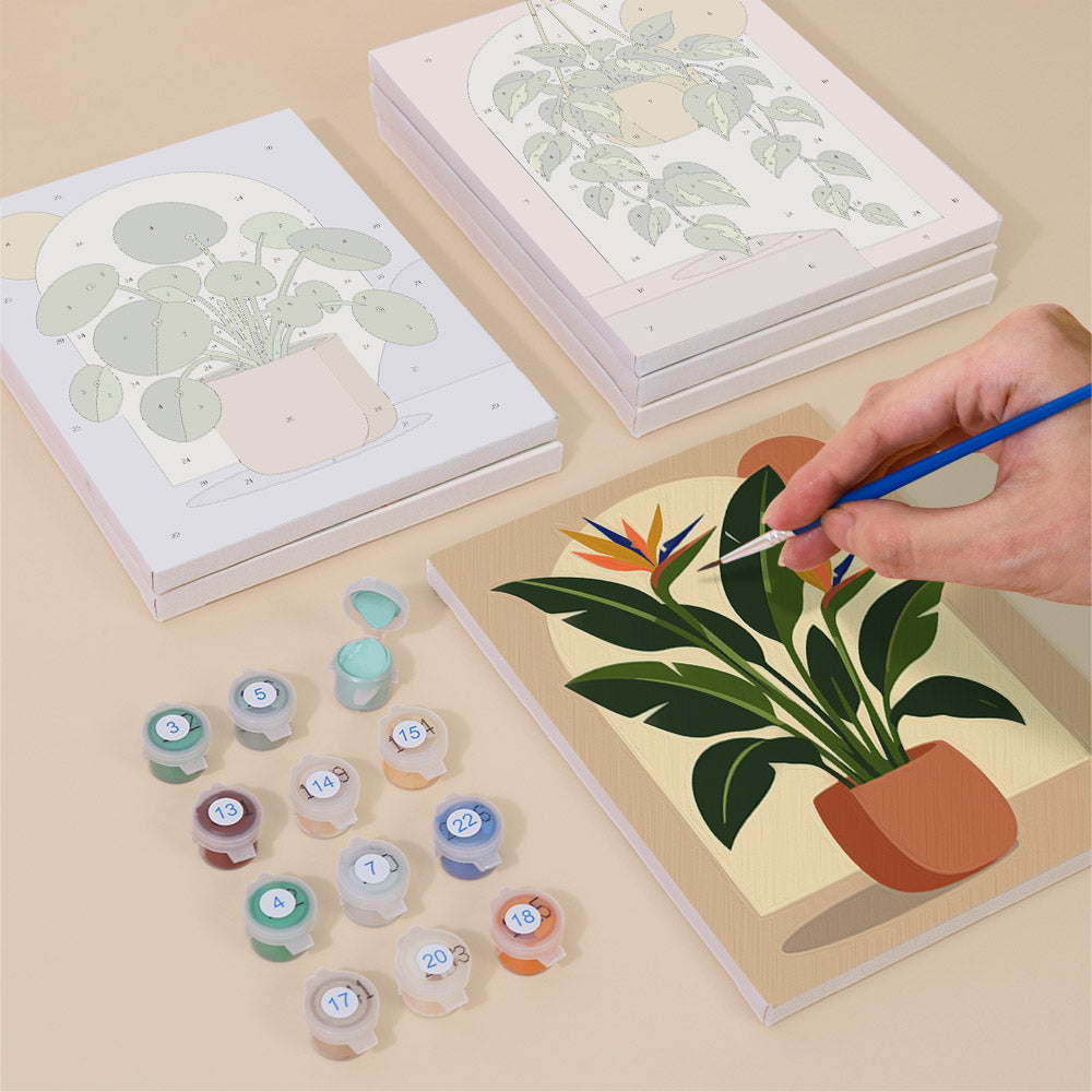 Painting one of the Potted Greens designs next to a stack of mini canvases