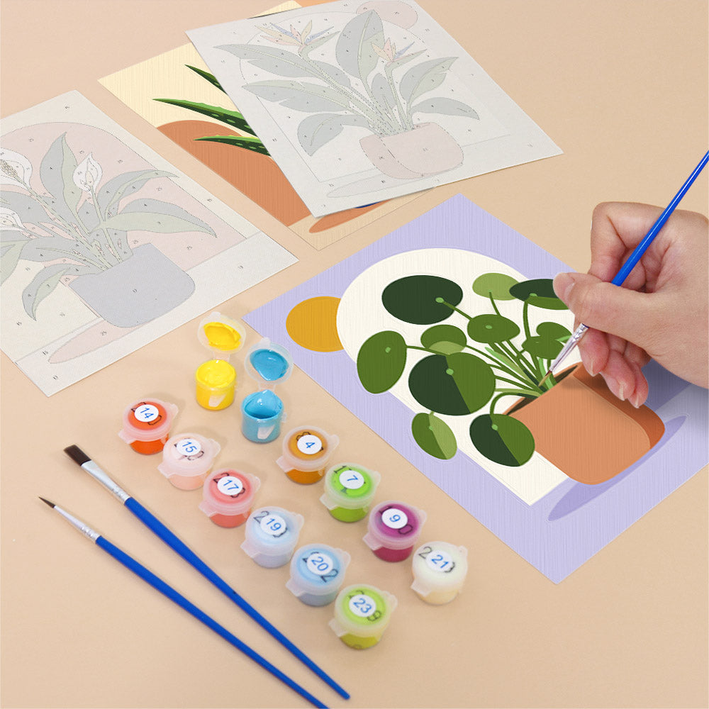 Filling in a Potted Greens mini canvas with numbered acrylic paints and a fine brush