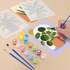 Filling in a Potted Greens mini canvas with numbered acrylic paints and a fine brush