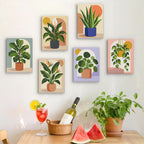 Six finished Potted Greens mini paintings hung on a wall above a table