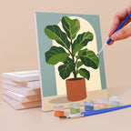 Painting a Potted Greens mini canvas propped up beside numbered acrylic paints