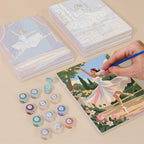 Painting one of the Prima Ballerina designs next to a stack of mini canvases