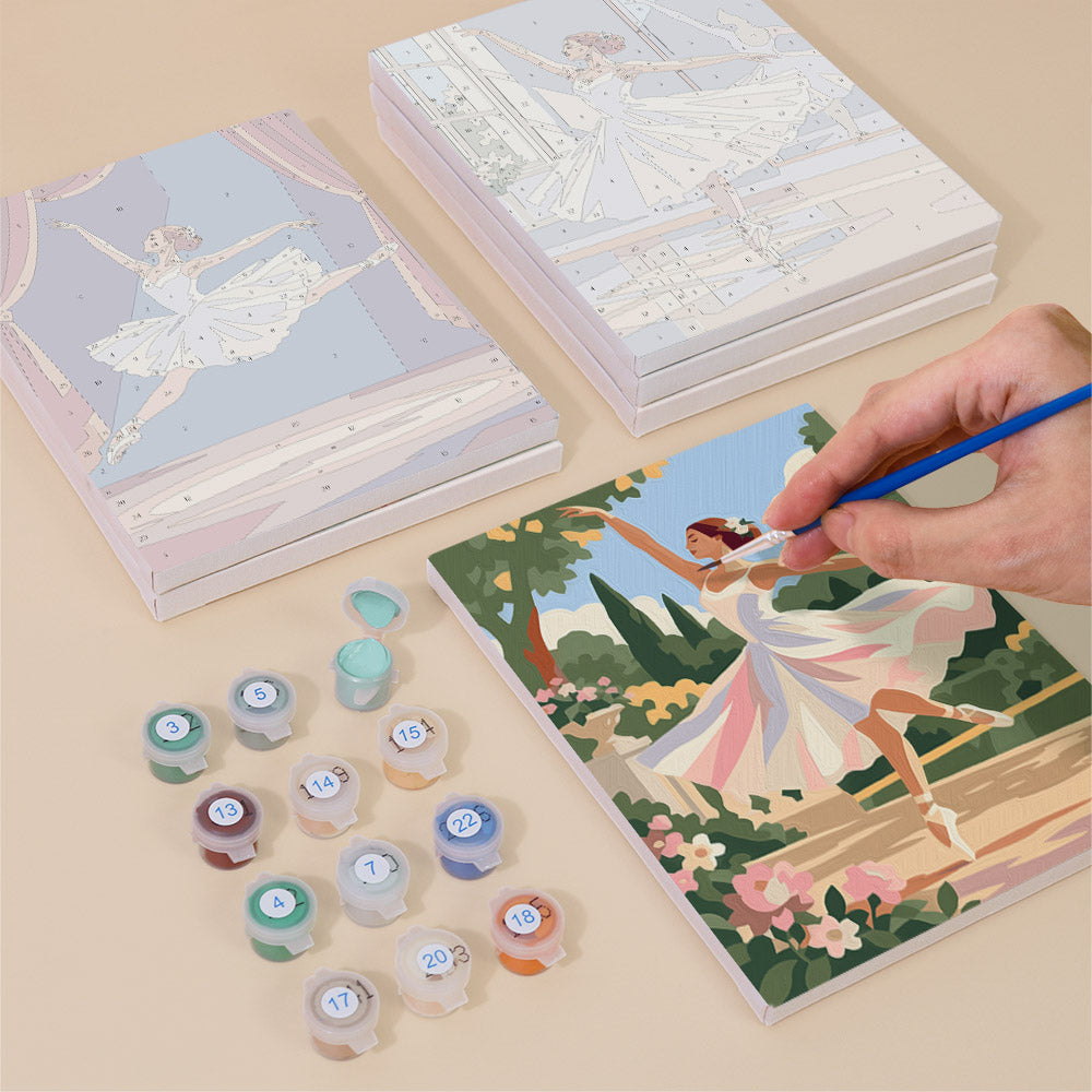 Painting one of the Prima Ballerina designs next to a stack of mini canvases