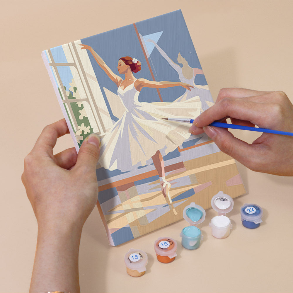Hand holding a Prima Ballerina mini canvas while painting the details