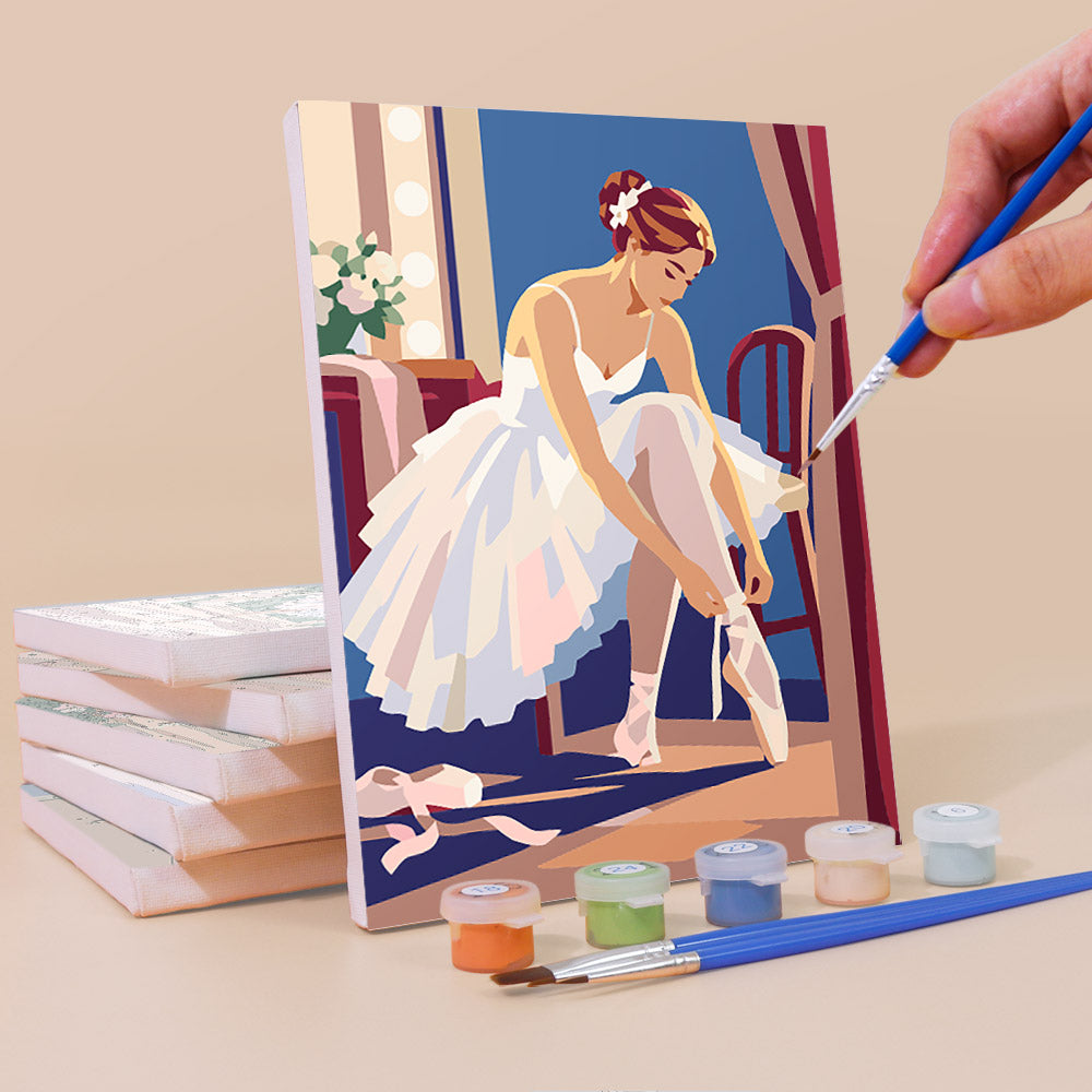 Painting a Prima Ballerina mini canvas propped up beside numbered acrylic paints