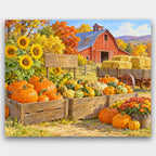 Pumpkin Farm Stand paint by numbers kit of a farm stand with crates of pumpkins and gourds, sunflowers, a hay wagon and a red barn