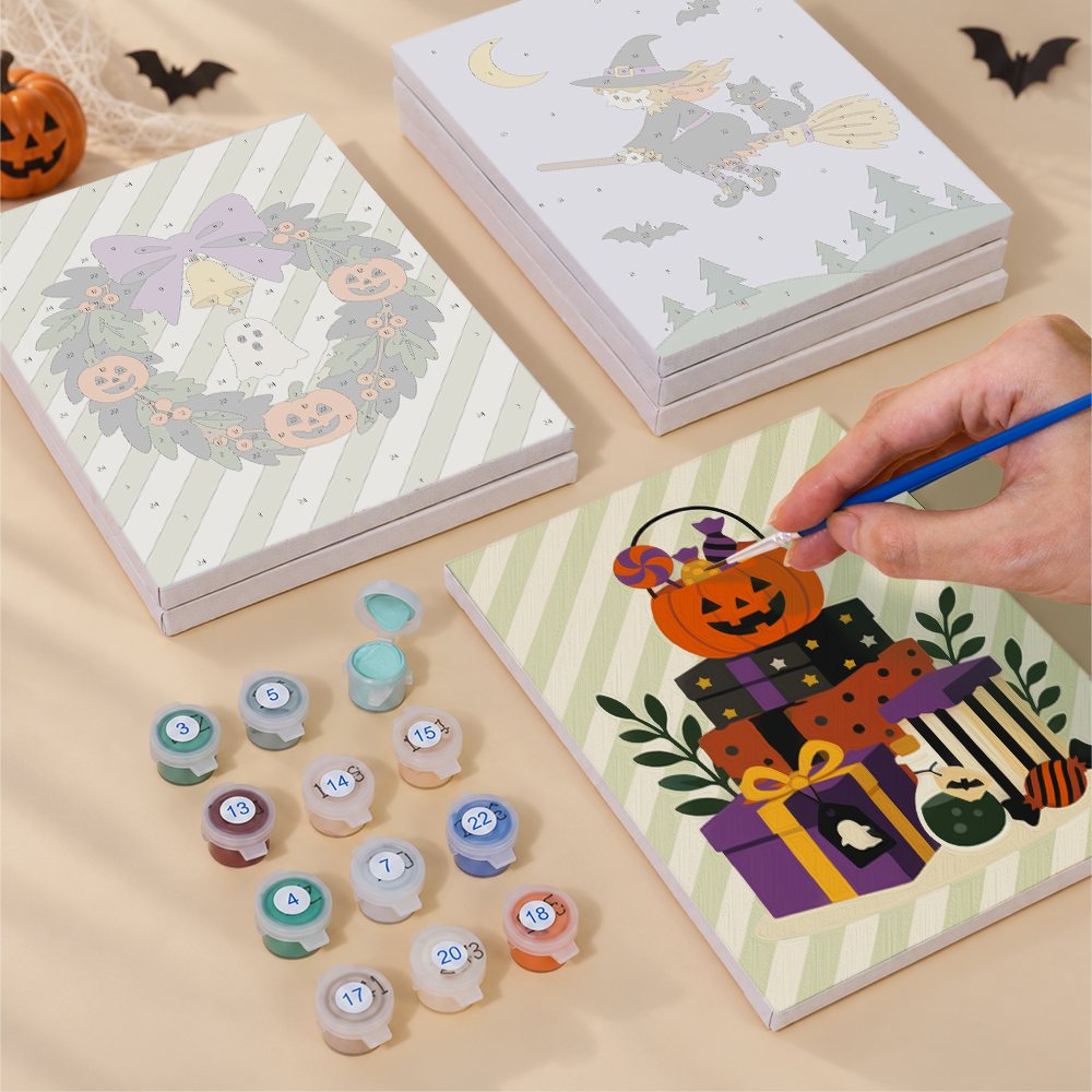 Painting one of the Pumpkin Festivities designs next to a stack of mini canvases