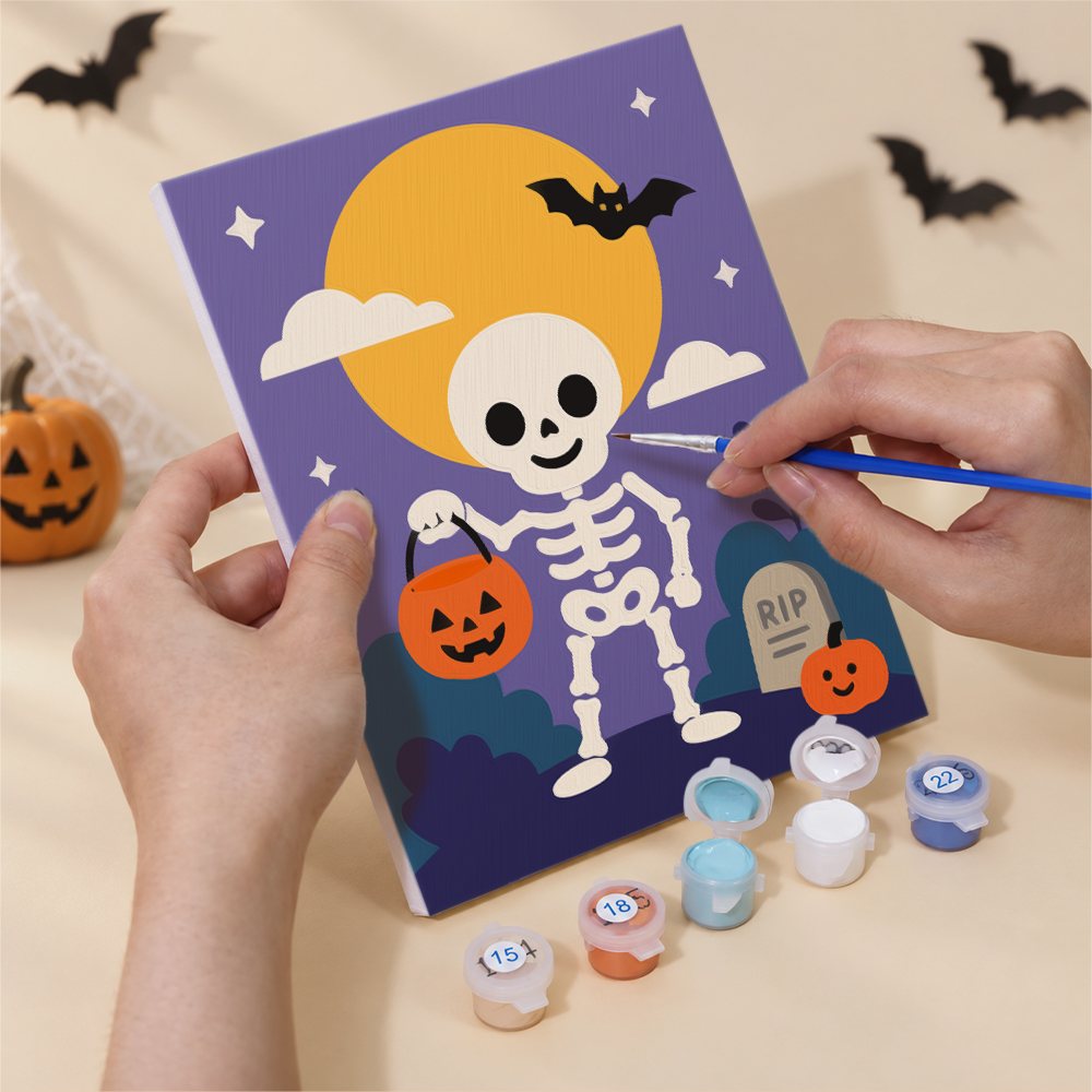 Hand holding a Purple Moon Spooks mini canvas while painting the details