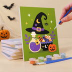 Painting a Purple Moon Spooks mini canvas propped up beside numbered acrylic paints