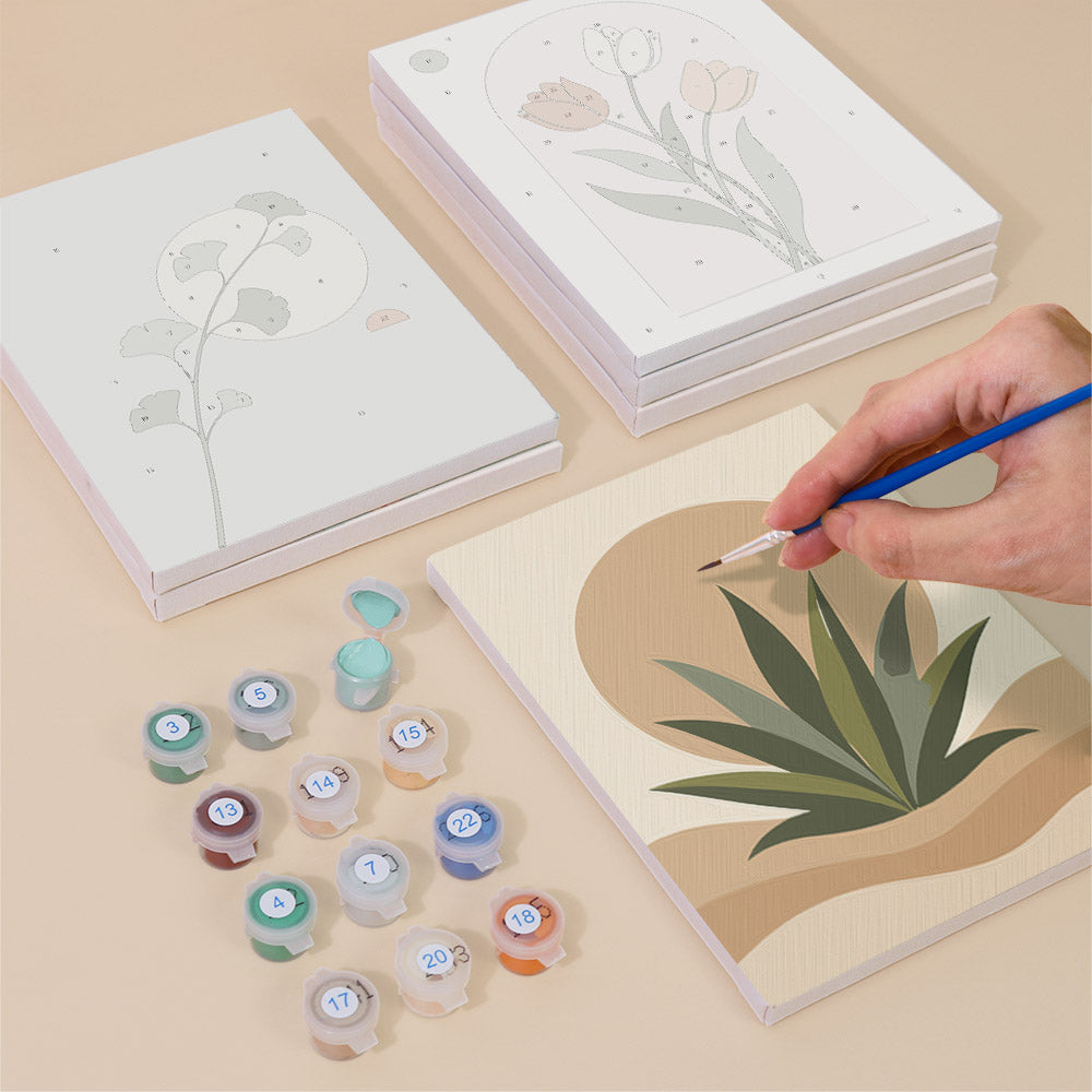 Painting one of the Quiet Botanicals designs next to a stack of mini canvases