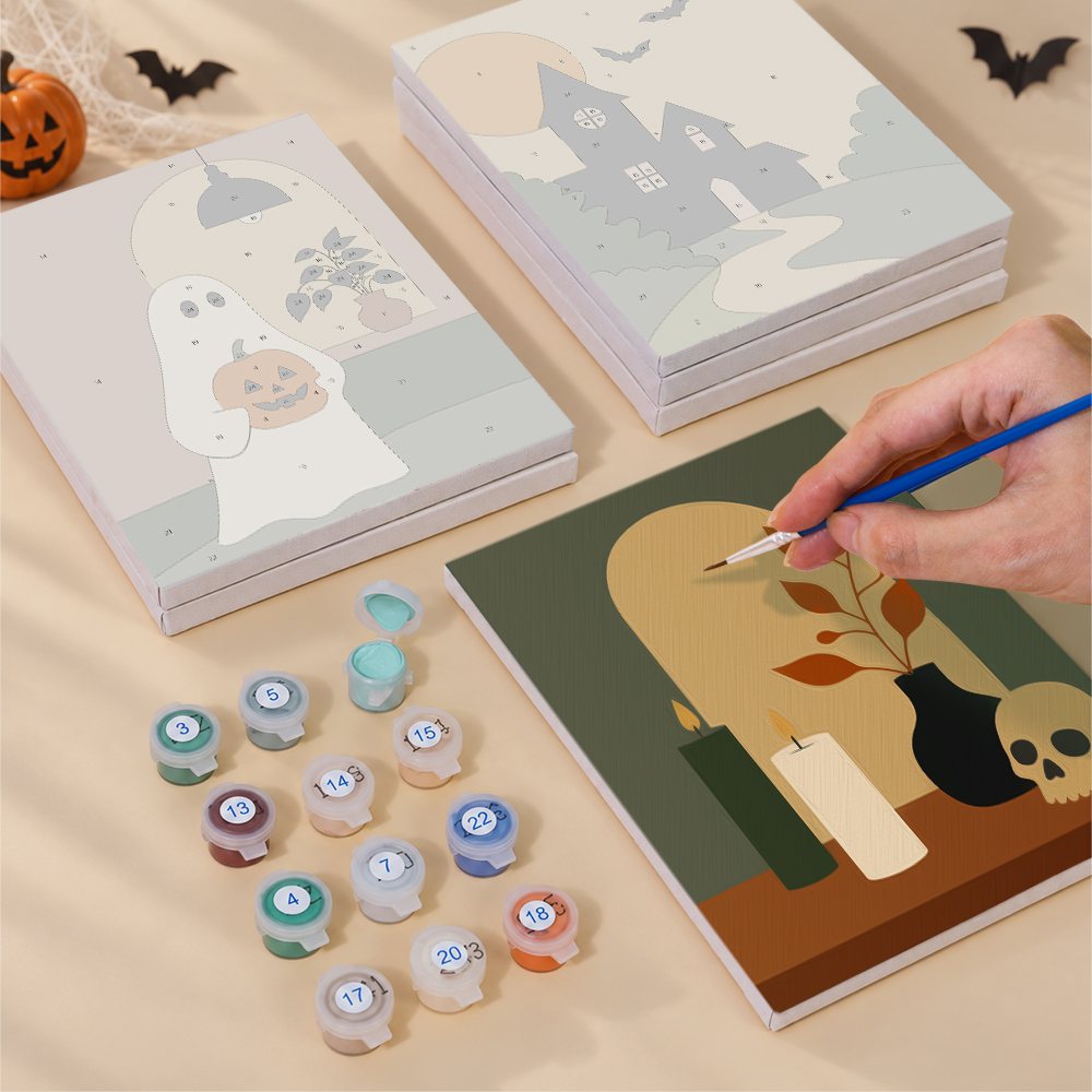 Painting one of the Quiet Hauntings designs next to a stack of mini canvases