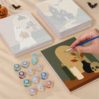 Painting one of the Quiet Hauntings designs next to a stack of mini canvases