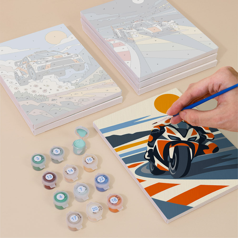Painting one of the Race Day designs next to a stack of mini canvases