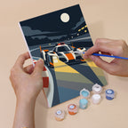 Hand holding a Race Day mini canvas while painting the details