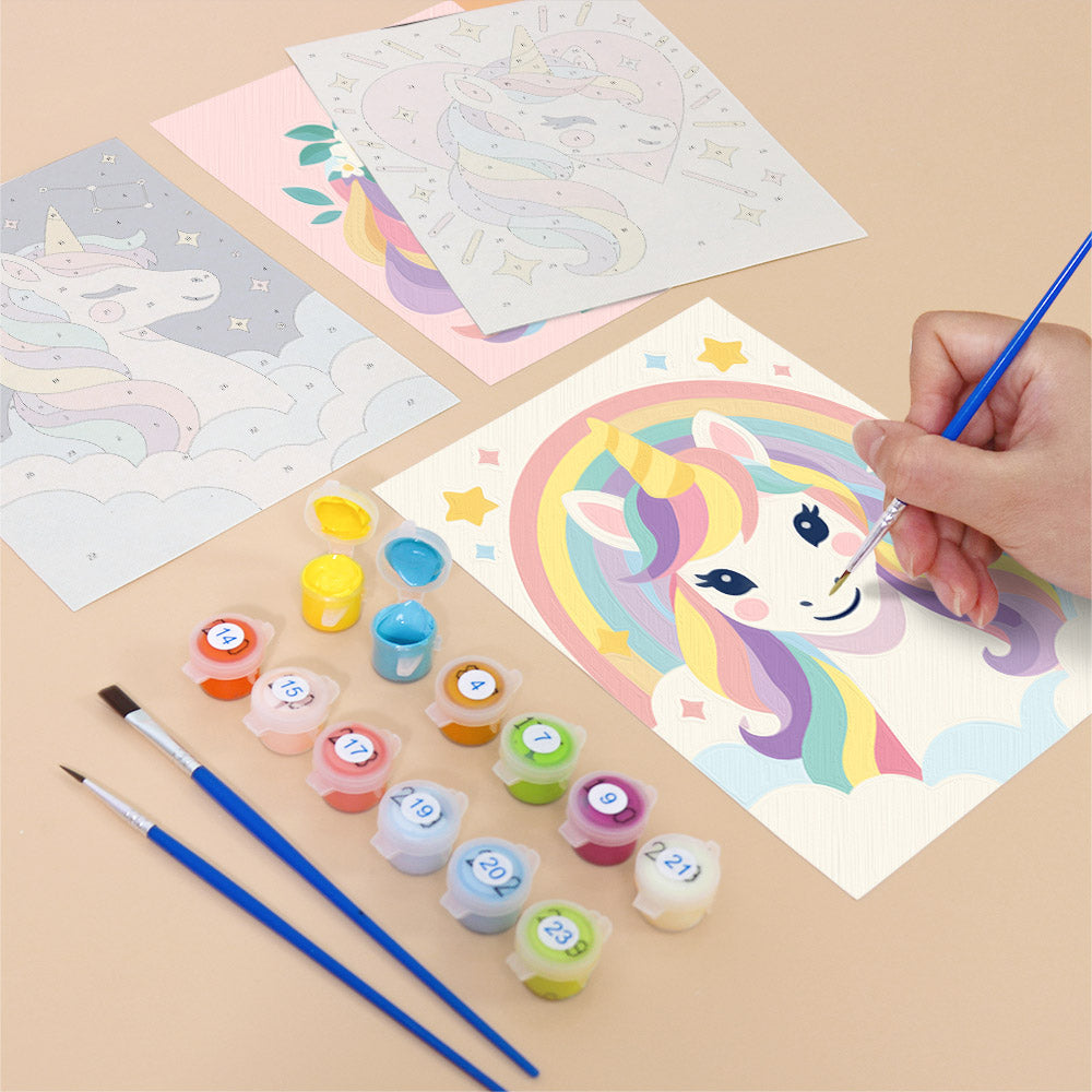 Filling in a Rainbow Unicorns mini canvas with numbered acrylic paints and a fine brush