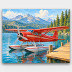 Red Seaplane at the Dock paint by numbers kit of a vintage red seaplane moored at a lake dock with pines and mountains