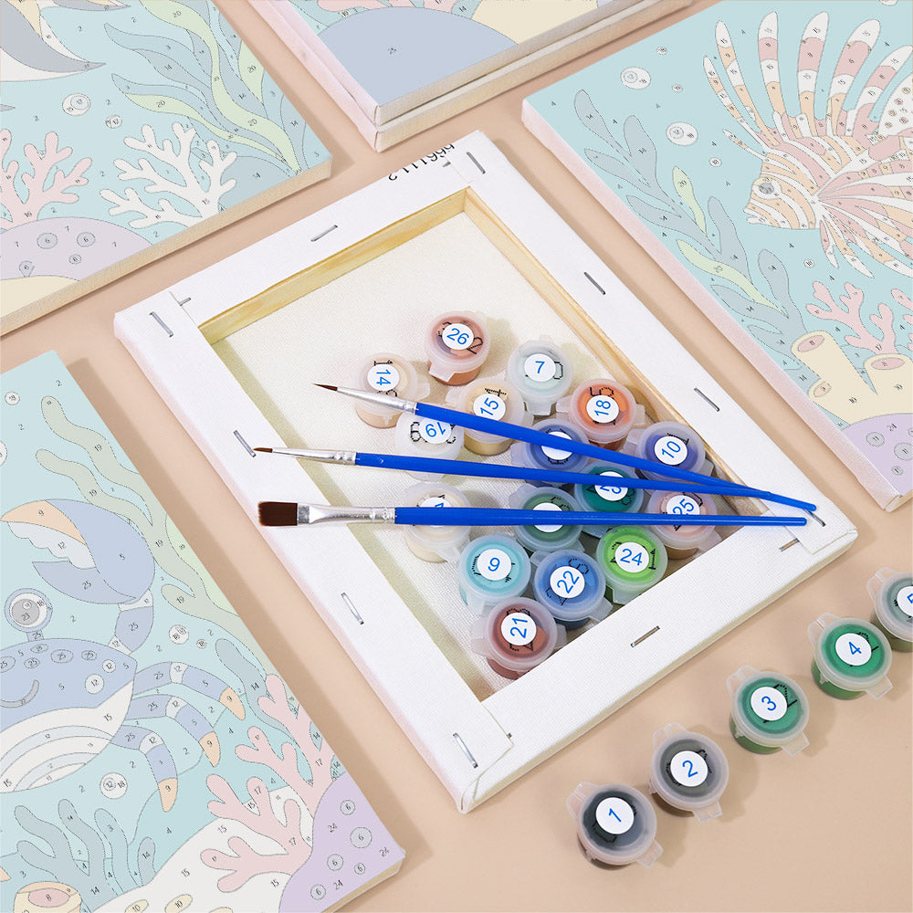 Numbered paint pots and brushes on a pre-stretched Reef Friends mini canvas