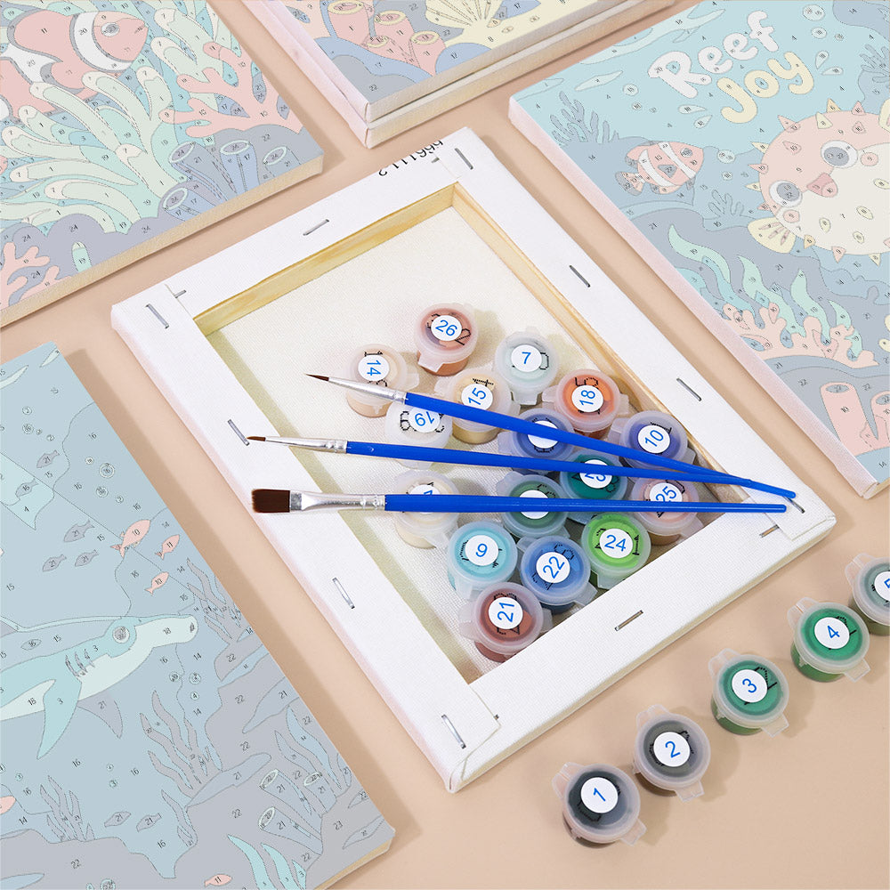 Numbered paint pots and brushes on a pre-stretched Reef Joy mini canvas