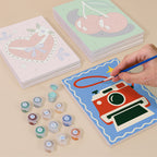 Painting one of the Retro Charms designs next to a stack of mini canvases