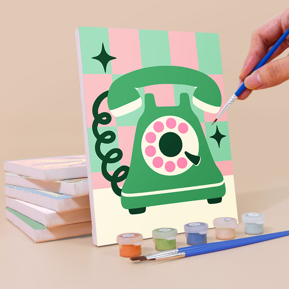 Painting a Retro Charms mini canvas propped up beside numbered acrylic paints