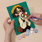 Hand holding a Retro Curls mini canvas while painting the details