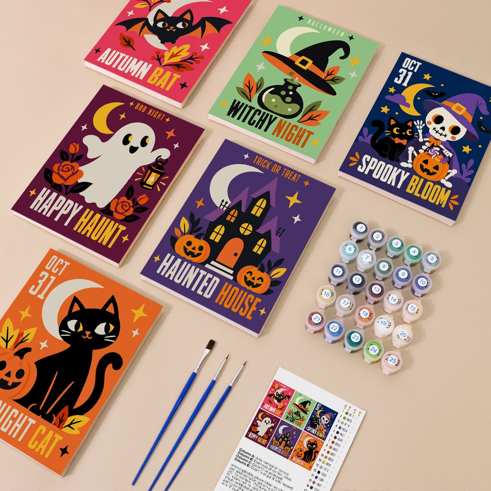 Painting one of the Retro Halloween Posters designs next to a stack of mini canvases