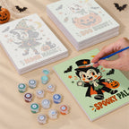 Painting one of the Retro Spooky Pals designs next to a stack of mini canvases