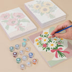 Painting one of the Ribbon Bouquets designs next to a stack of mini canvases