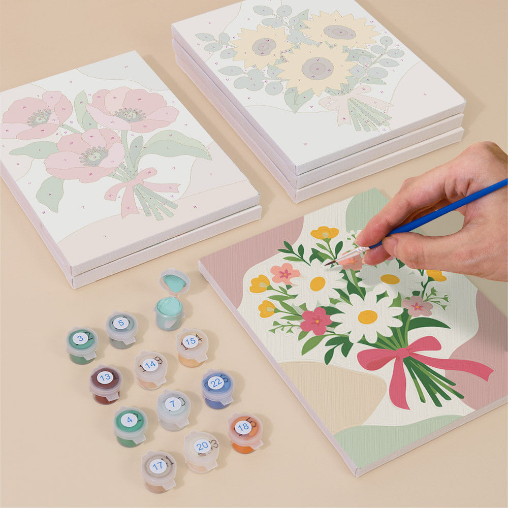 Painting one of the Ribbon Bouquets designs next to a stack of mini canvases