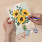 Hand holding a Ribbon Bouquets mini canvas while painting the details