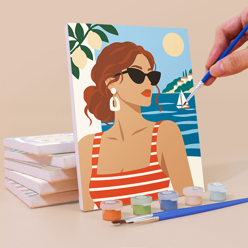 Painting a Riviera Chic mini canvas propped up beside numbered acrylic paints