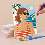 Painting a Riviera Chic mini canvas propped up beside numbered acrylic paints