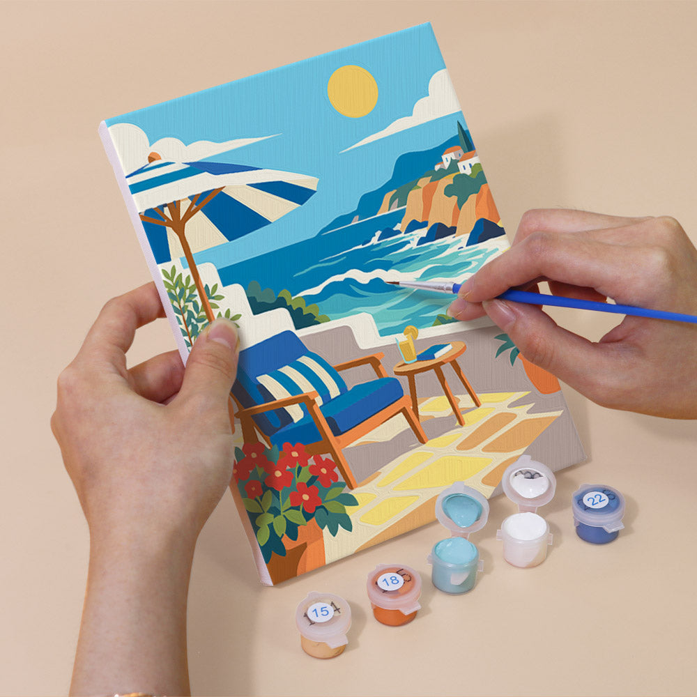 Hand holding a Rolling Waves mini canvas while painting the details