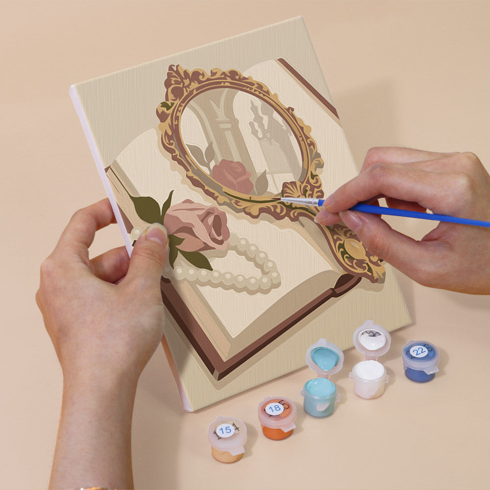 Hand holding a Rose Boudoir mini canvas while painting the details