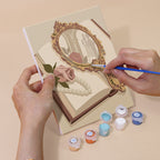 Hand holding a Rose Boudoir mini canvas while painting the details