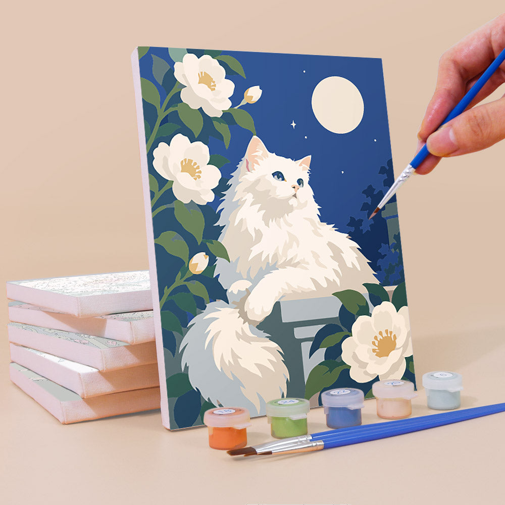 Painting a Roses and Whiskers mini canvas propped up beside numbered acrylic paints