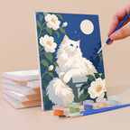 Painting a Roses and Whiskers mini canvas propped up beside numbered acrylic paints