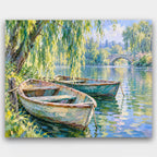 Rowboats Under the Willow paint by numbers kit of two weathered rowboats moored under a weeping willow on a calm river with a stone bridge