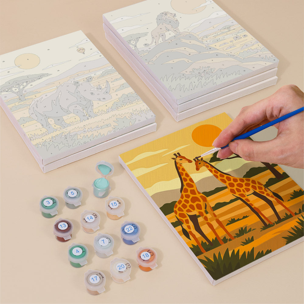 Painting one of the Safari Sunset designs next to a stack of mini canvases
