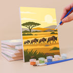 Painting a Safari Sunset mini canvas propped up beside numbered acrylic paints
