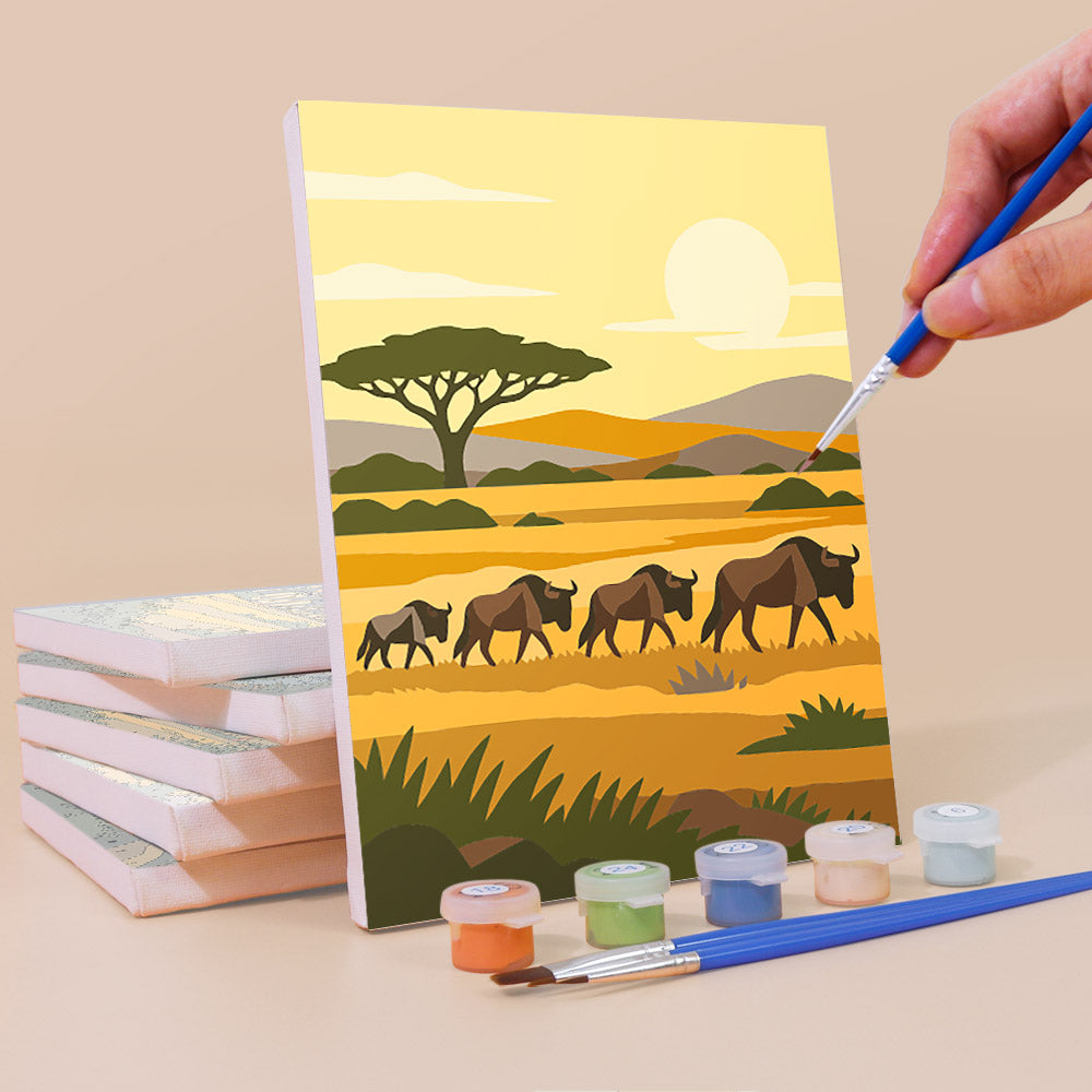 Painting a Safari Sunset mini canvas propped up beside numbered acrylic paints