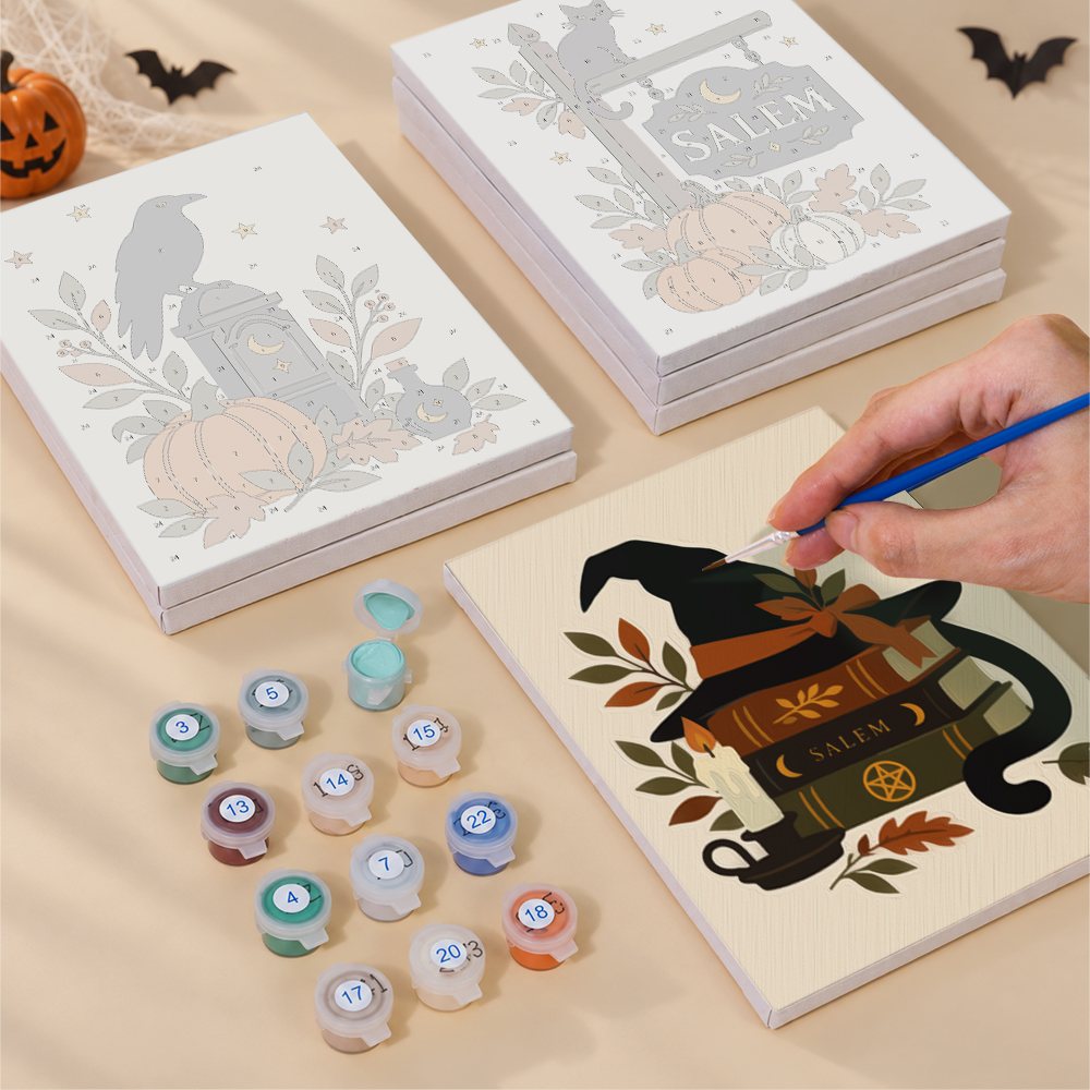 Painting one of the Salem Black Cat Autumn designs next to a stack of mini canvases