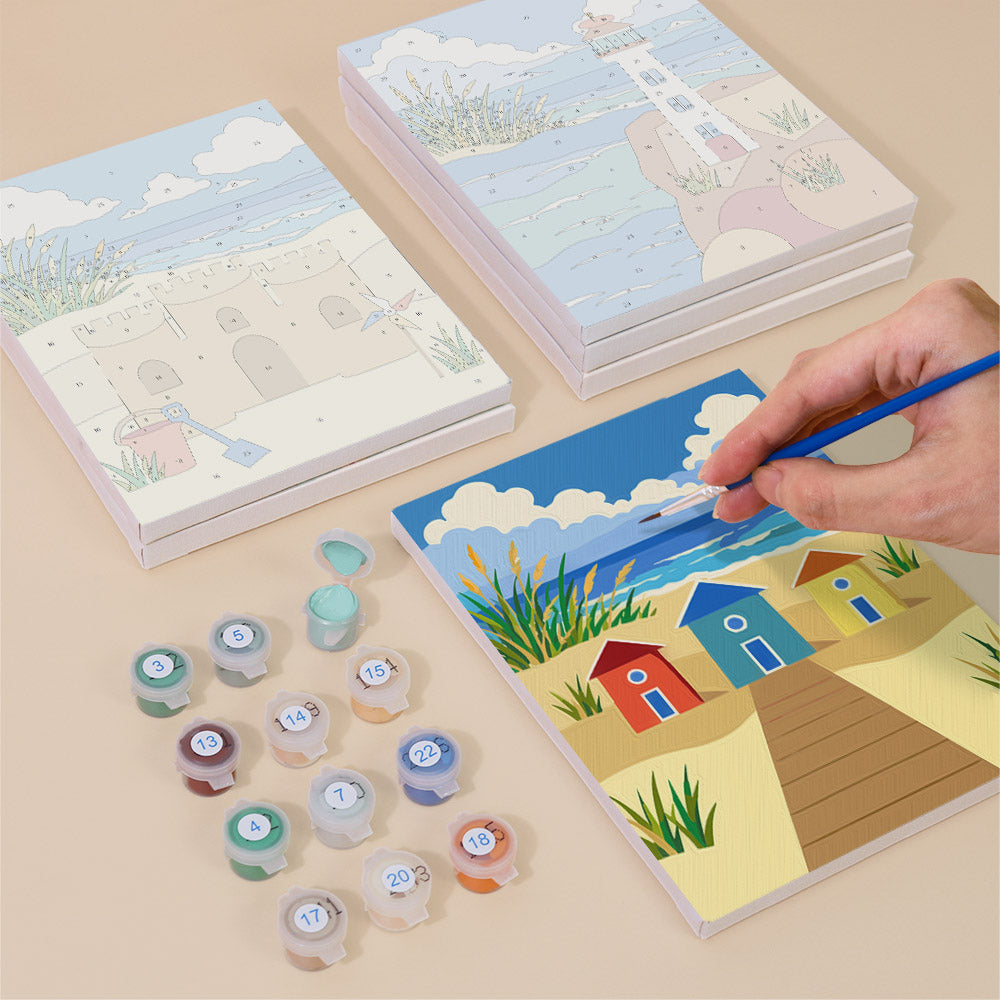Painting one of the Sandy Summer designs next to a stack of mini canvases