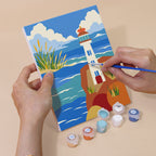 Hand holding a Sandy Summer mini canvas while painting the details