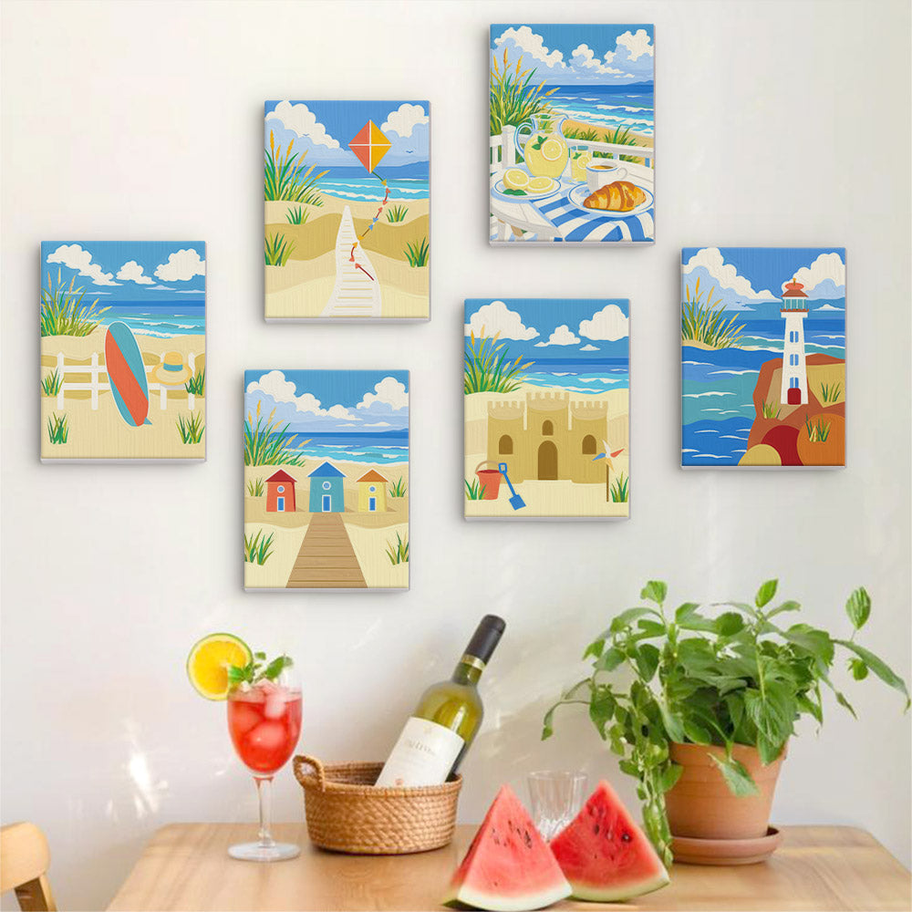 Six finished Sandy Summer mini paintings hung on a wall above a table
