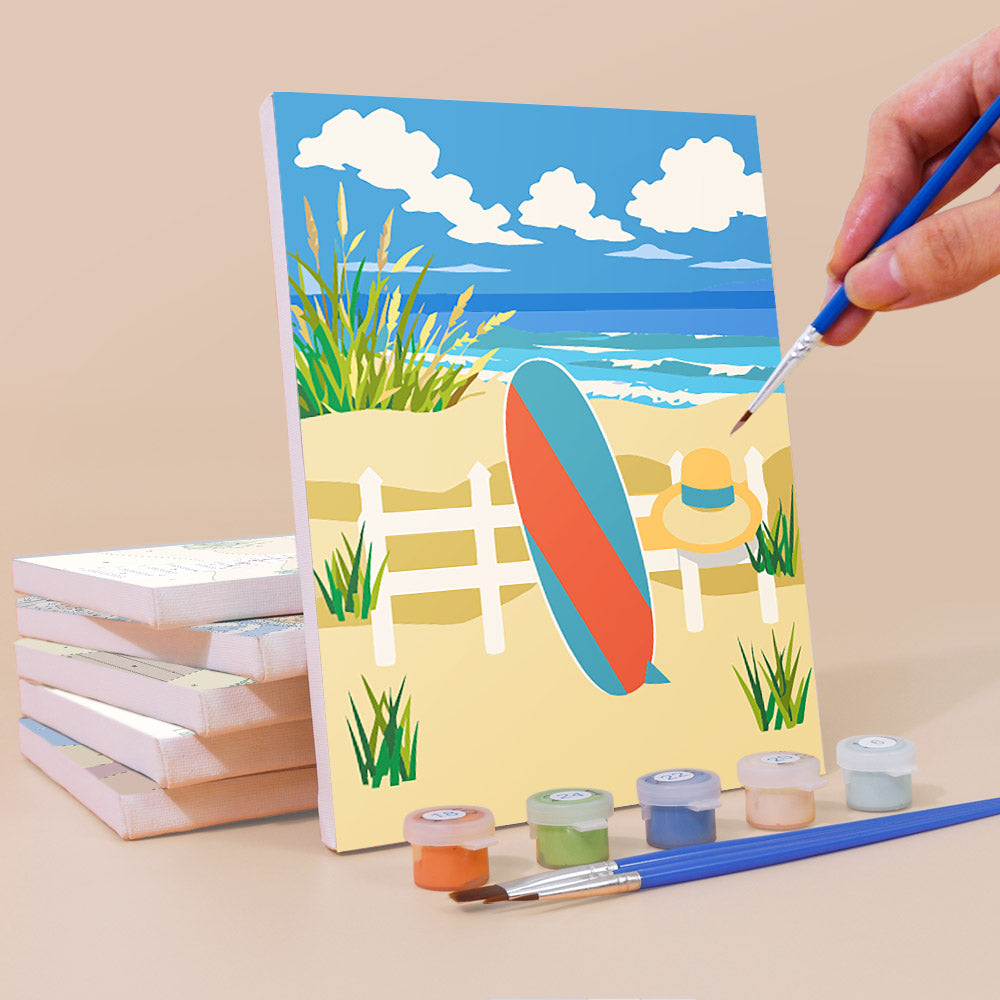 Painting a Sandy Summer mini canvas propped up beside numbered acrylic paints