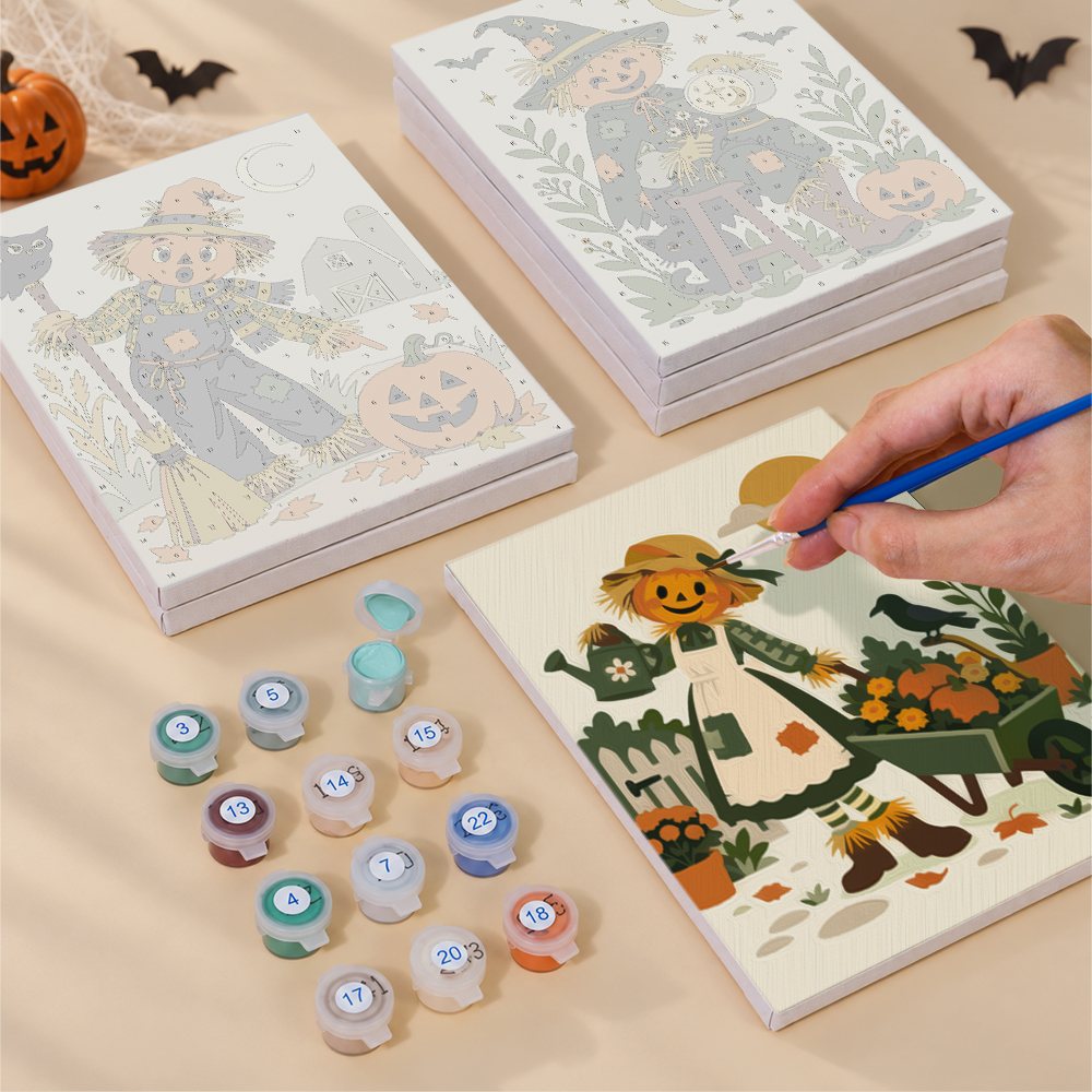 Painting one of the Scarecrow Harvest Friends designs next to a stack of mini canvases