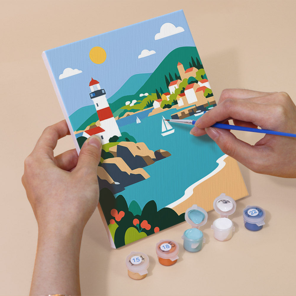 Hand holding a Scenic Escapes mini canvas while painting the details