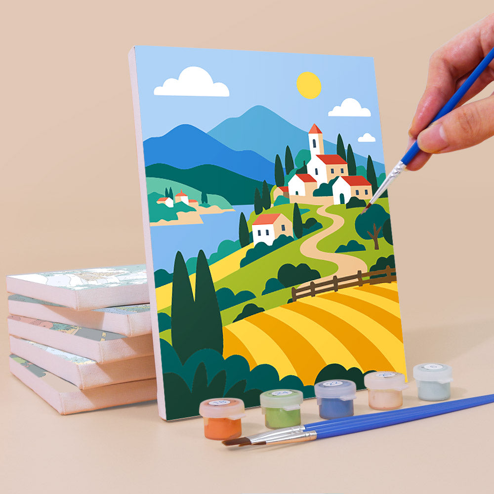 Painting a Scenic Escapes mini canvas propped up beside numbered acrylic paints